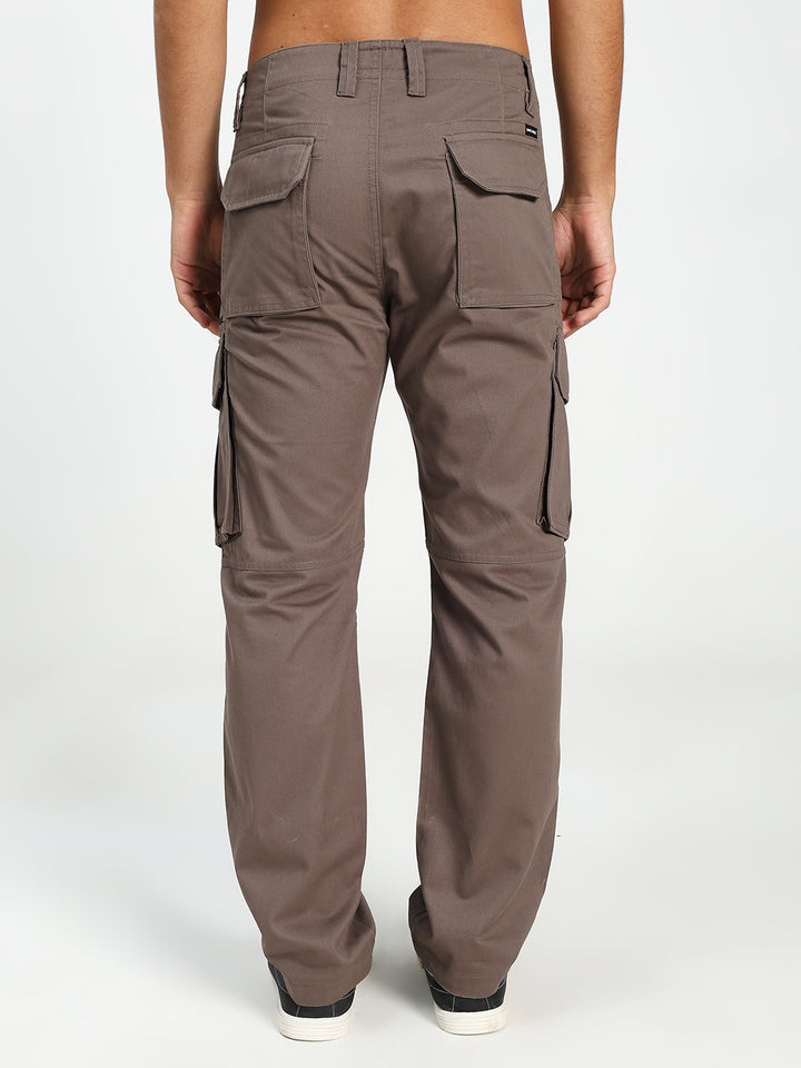 Brown cargo pants worn by a man on a white background