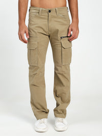 Beige cargo pants worn by a man on a white background