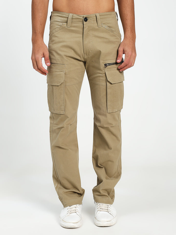 Beige cargo pants worn by a man on a white background
