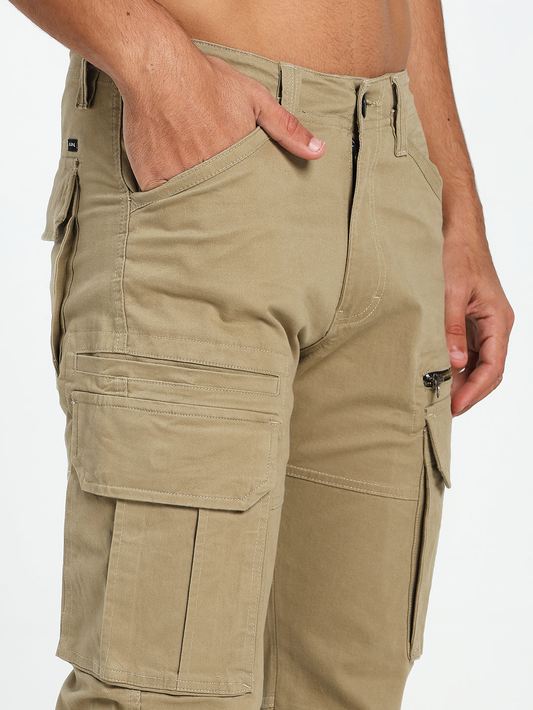 Beige cargo pant worn by a man on a white background