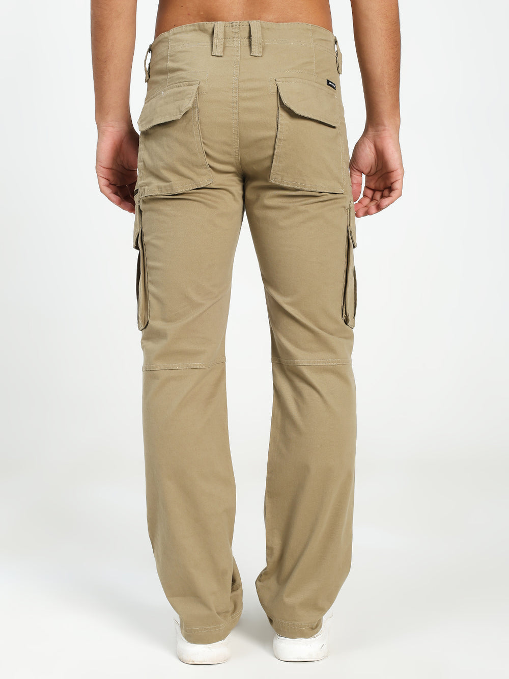 Beige cargo pants worn by a man on a white background