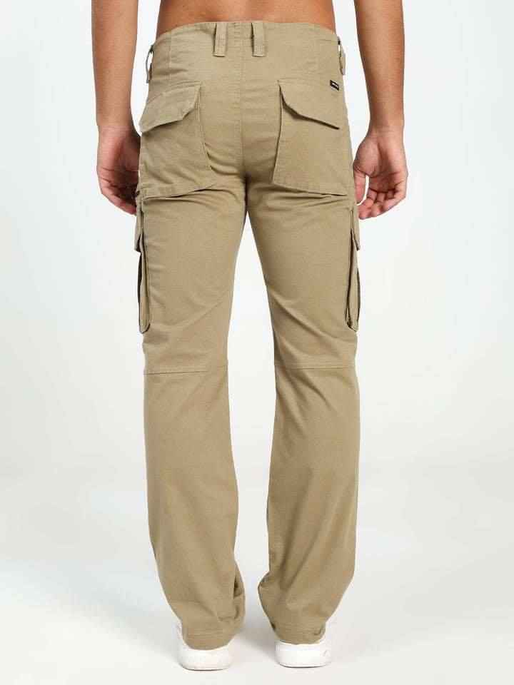 Beige cargo pants worn by a man on a white background
