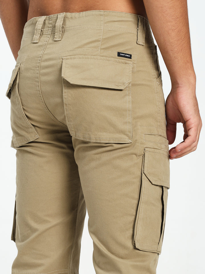Beige cargo pants with multiple pockets on a white background