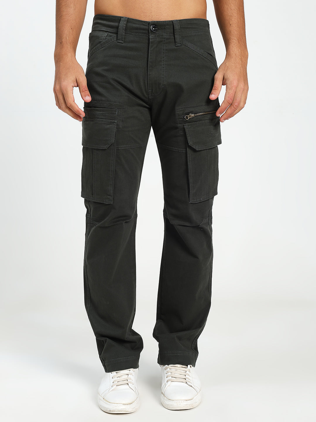 man wearing dark green cargo pants on a white background