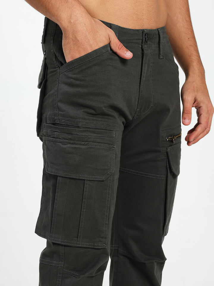 dark green cargo pants worn by a man on a white background