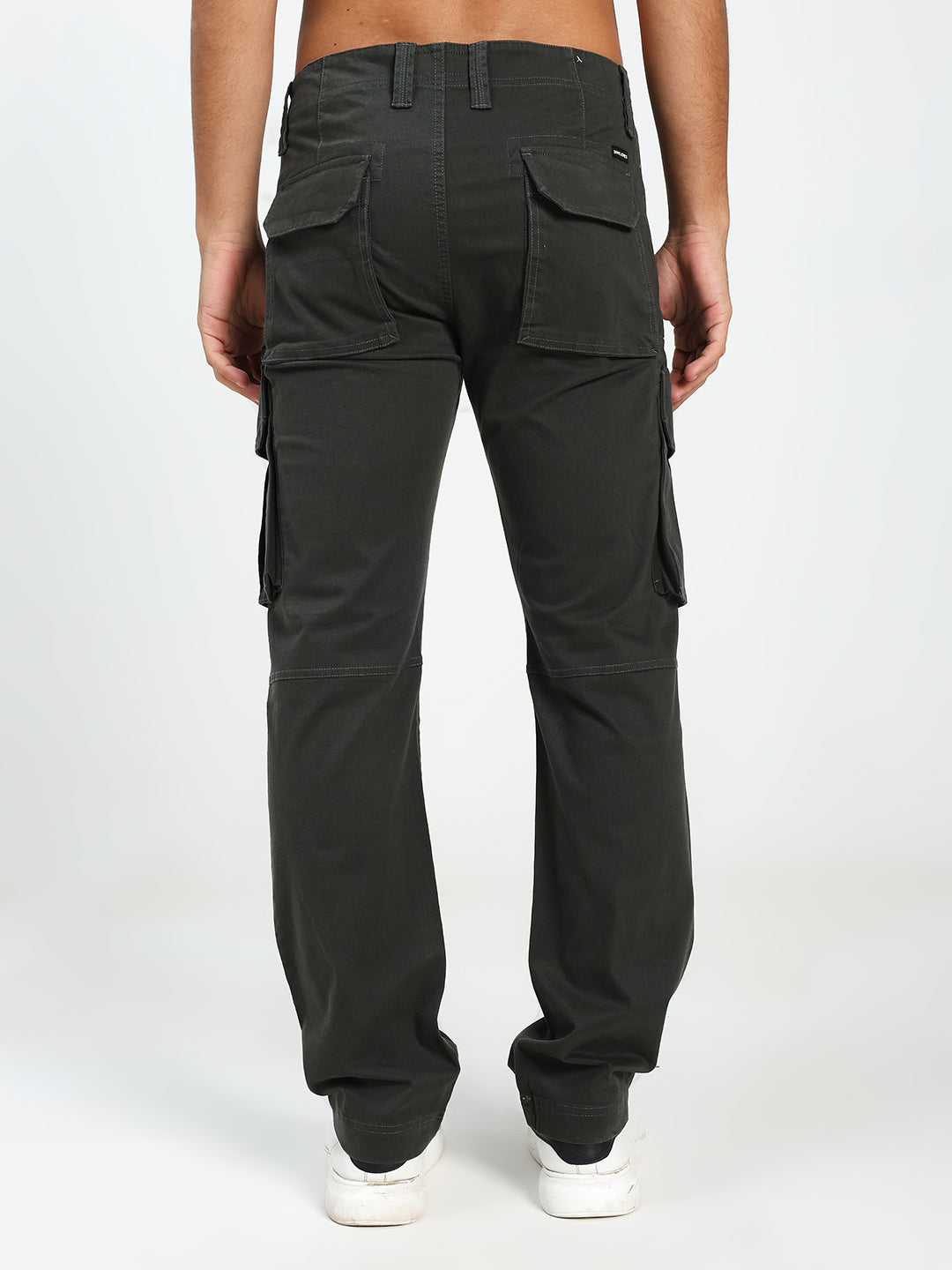dark geen cargo pants worn by a man on a white background