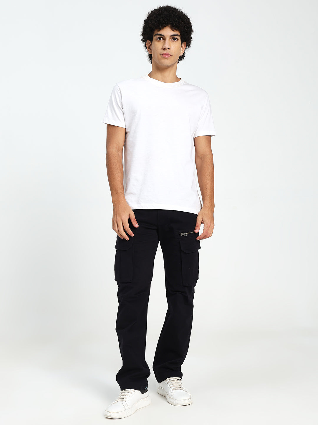 Person wearing a white t-shirt and black cargo pants on a white background