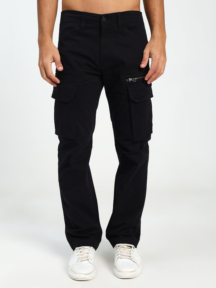 man wearing black cargo pants on a white background