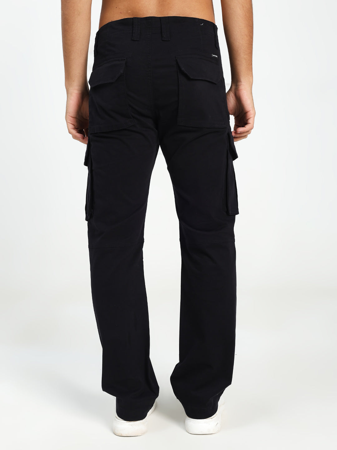 Black cargo pants worn by a man on a white background