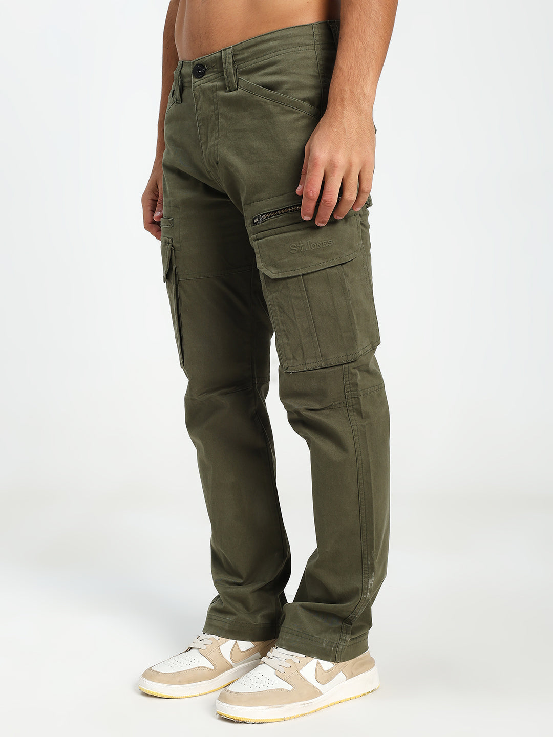 man wearing olive green cargo pants on a white background