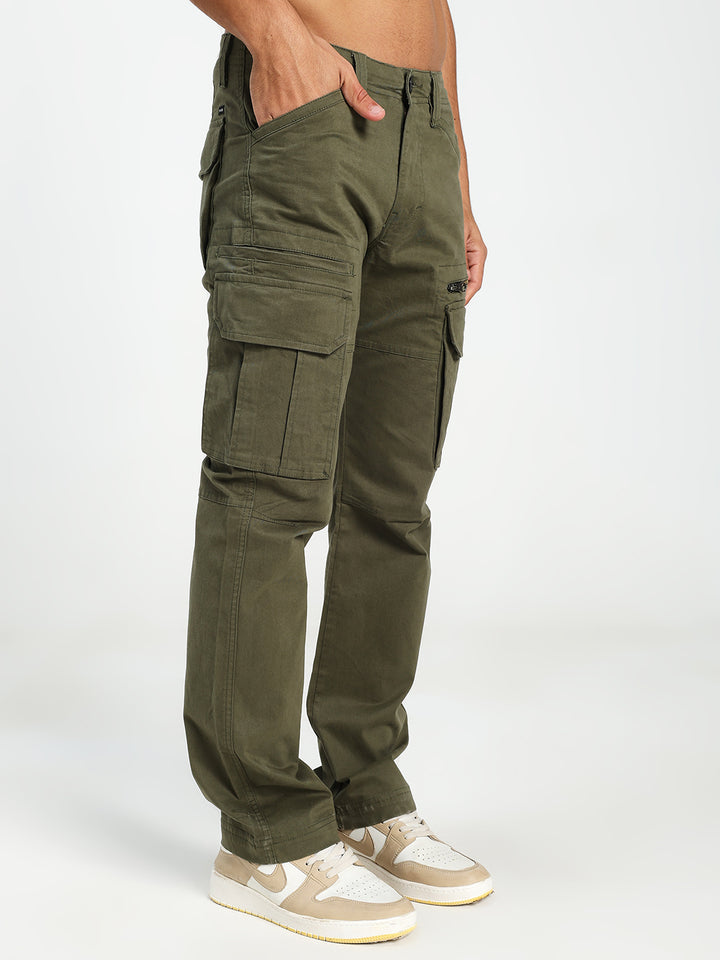 Olive green cargo pants worn by a man on a white background