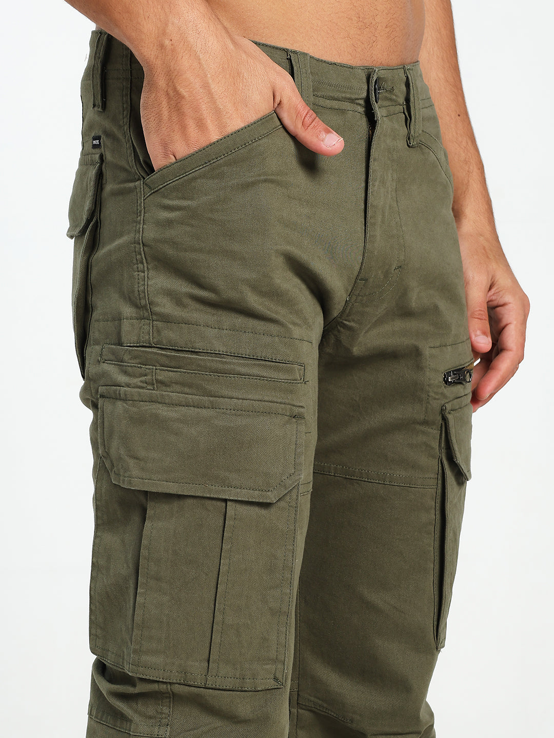 Olive green cargo pants worn by a man on a white background