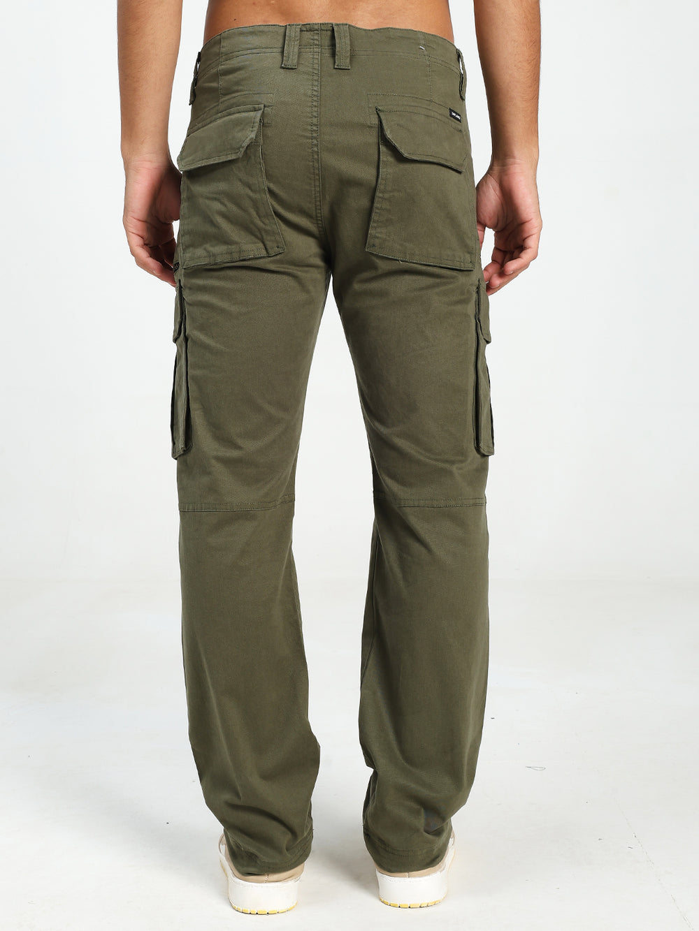 olive Green cargo pants worn by a person on a white background