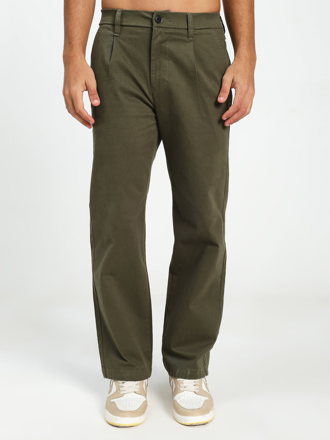 man wearing olive green korean pants on a white background
