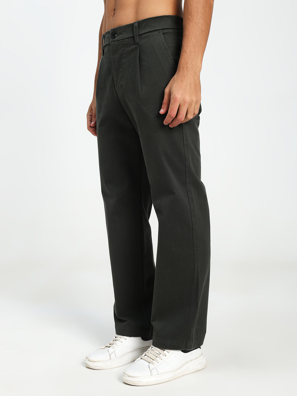 Man wearing Dark Green Korean pants and white sneakers on a white background