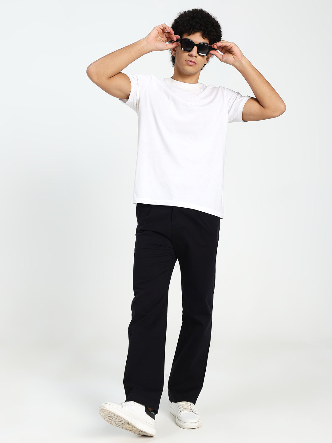 Man wearing a white t-shirt, black Korean pants, and sunglasses on a white background