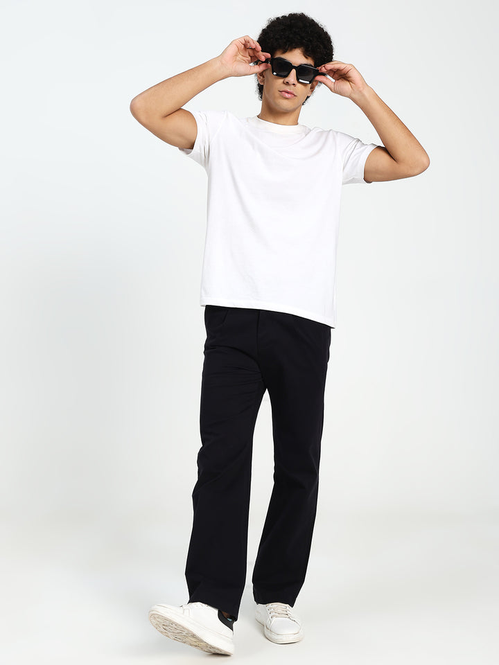 Man wearing a white t-shirt, black Korean pants, and sunglasses on a white background