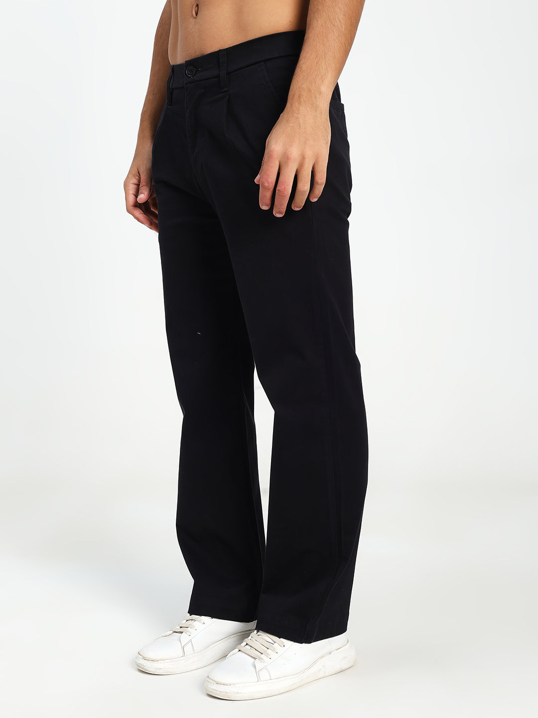 Man wearing black Korean pants and white sneakers on a white background