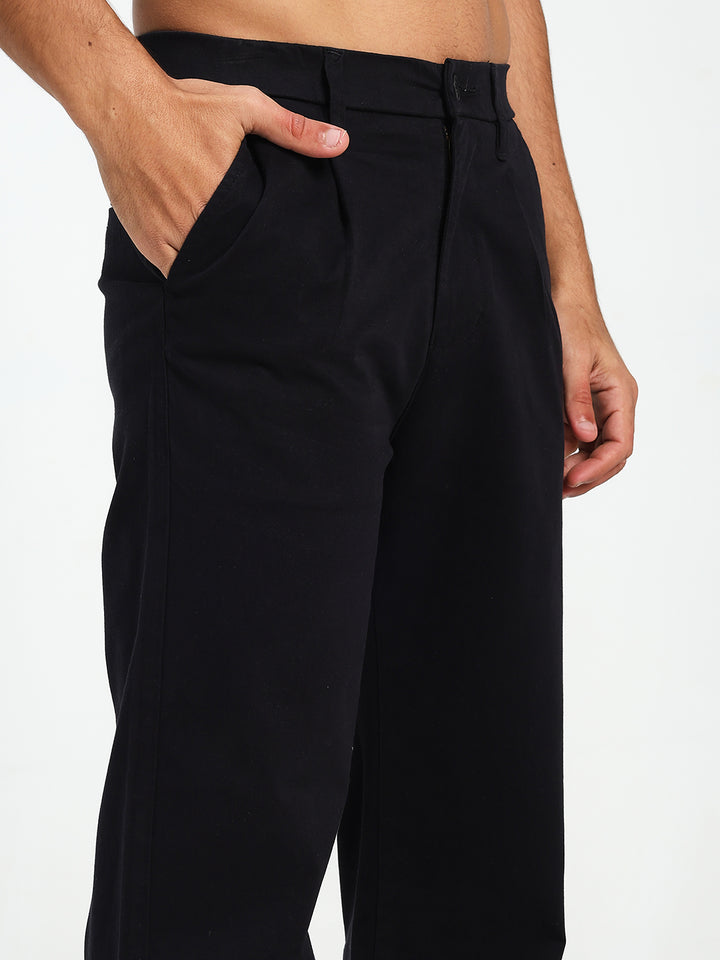 Black wide-leg Korean pants worn by a Man on a white background