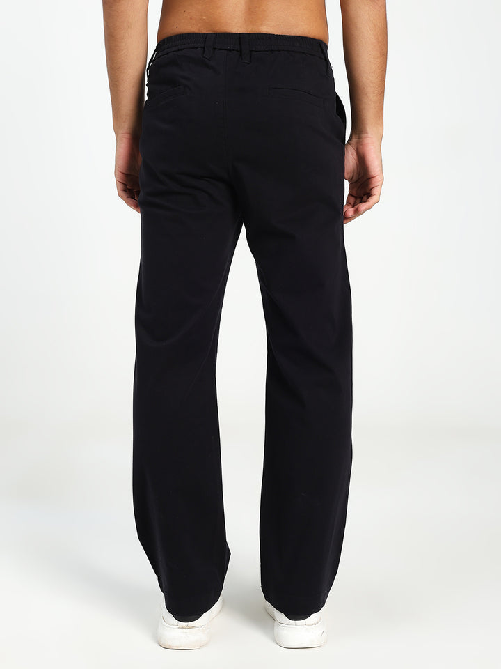 Man wearing black Korean pants on a white background