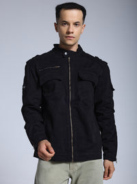 Man wearing a black jacket on a gray background