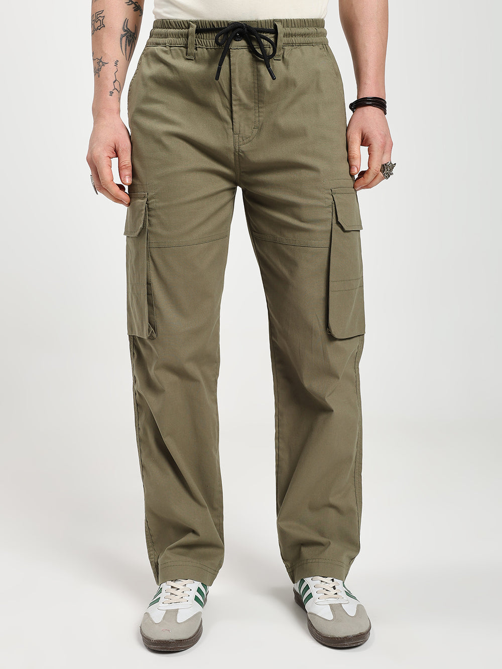 man wearing olive green cargo pants on a white background