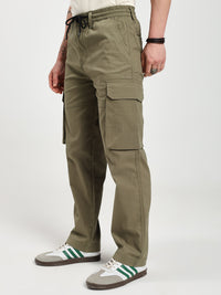 man wearing olive green cargo pants on a white background