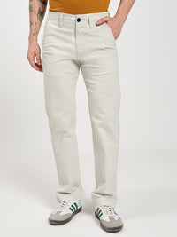 man wearing light-colored chinos pants on a white background