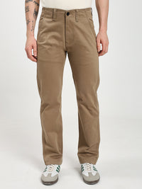 man wearing brown chinos pants on a white background