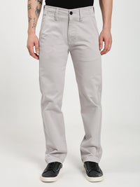 man wearing light gray chinos pants on a white background