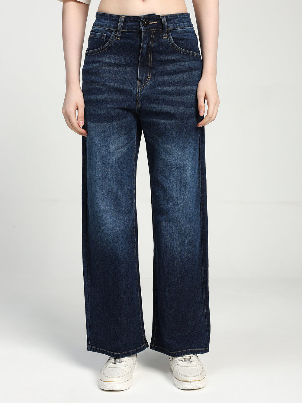 women wearing blue wide-leg jeans on a white background