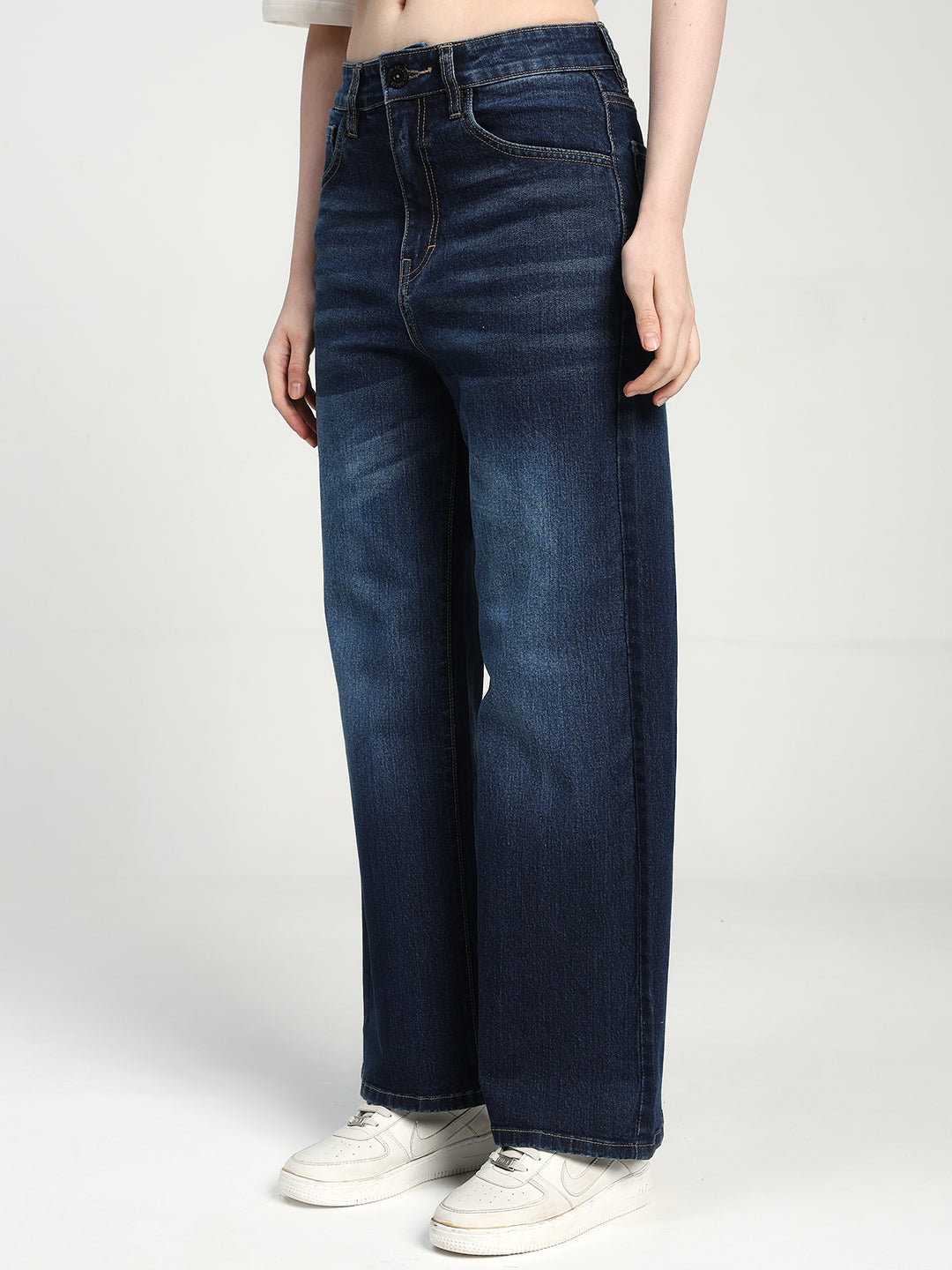 women wearing blue jeans on a white background