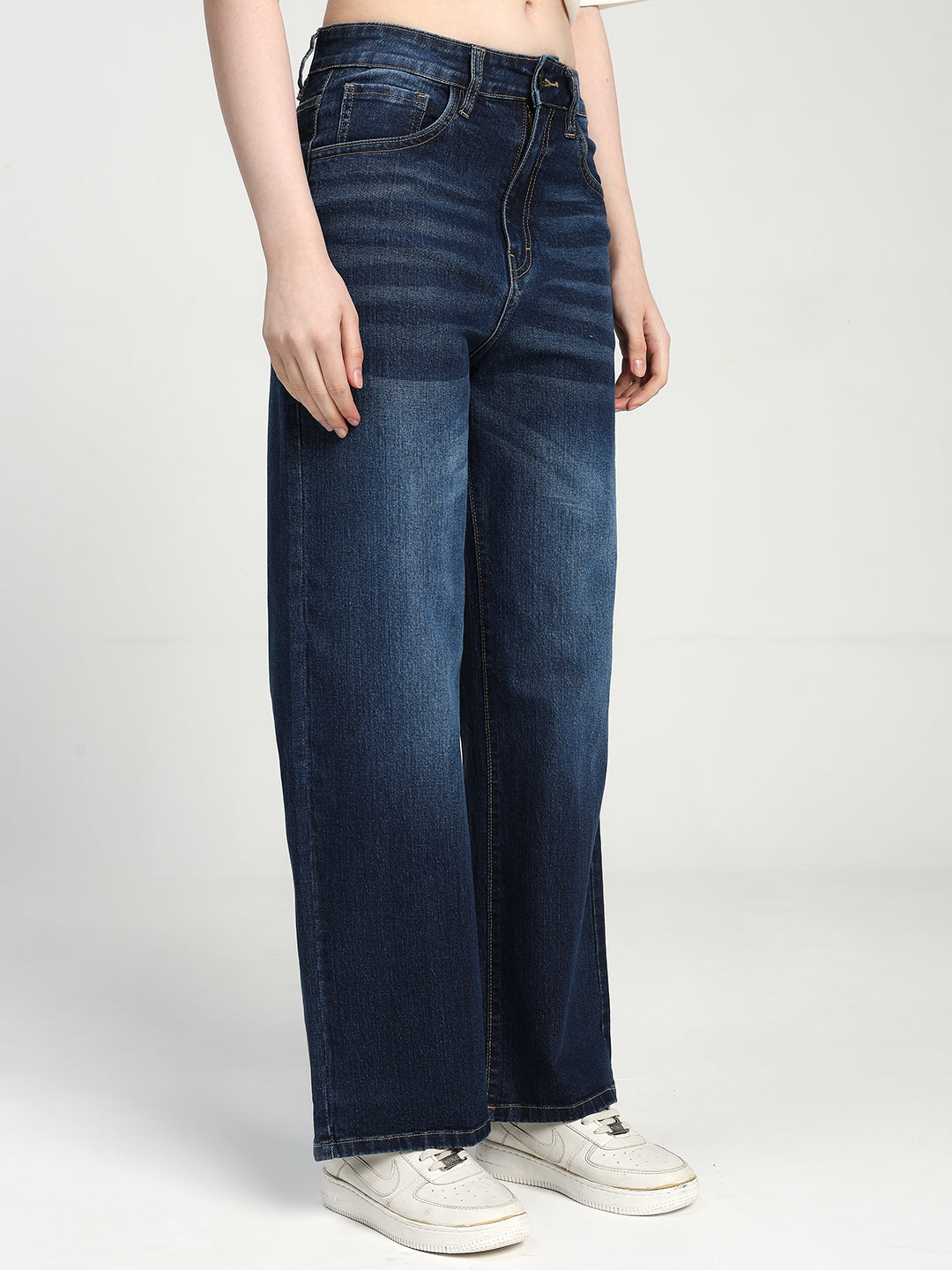 women wearing blue jeans on a white background