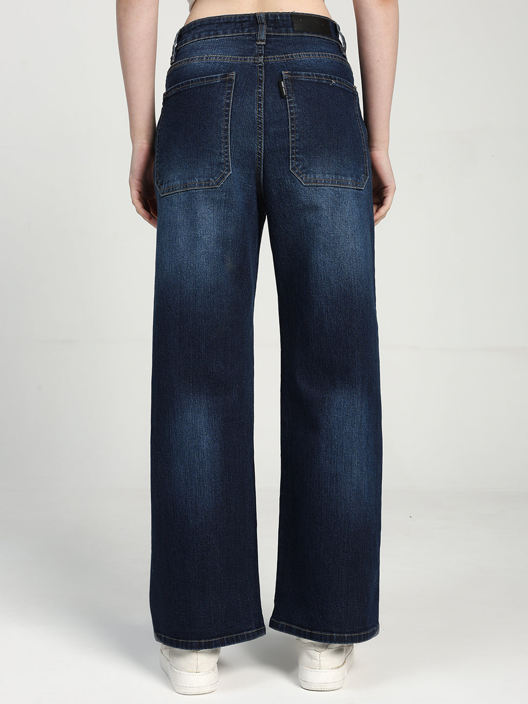 women wearing blue wide-leg jeans on a white background