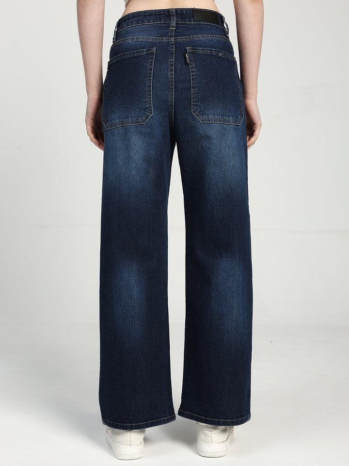 women wearing blue wide-leg jeans on a white background