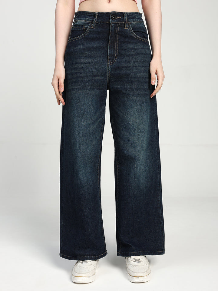 women wearing dark blue wide-leg jeans on a white background