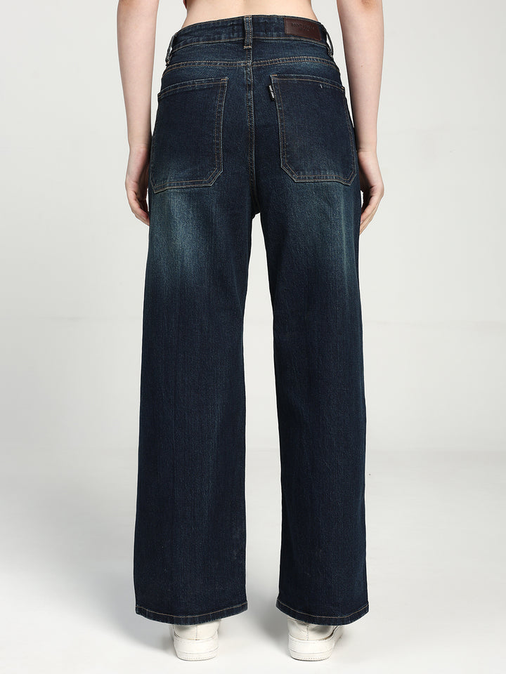 women wearing dak blue wide-leg jeans on a white background