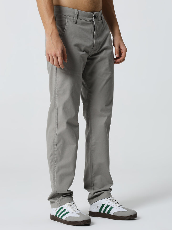 man wearing gray pants and shoes on a white background
