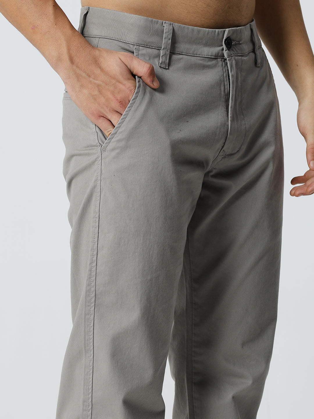 Gray pants worn by a man on a plain background