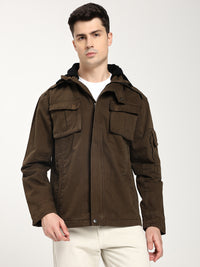 Man wearing a brown jacket with multiple pockets on a white background