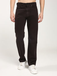 man wearing dark brown jeans and white shoes on a white background