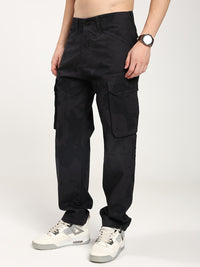 Man wearing black camouflage cargo pants on a white background