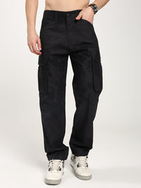 man wearing black camouflage cargo pants on a white background