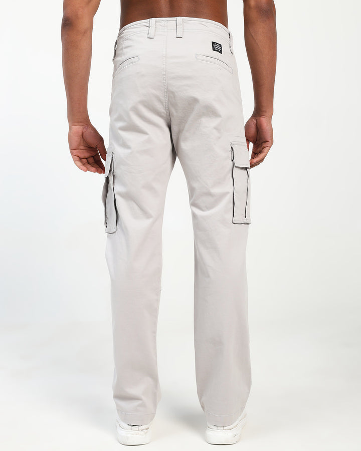 Light gray cargo pants worn by a man on a white background