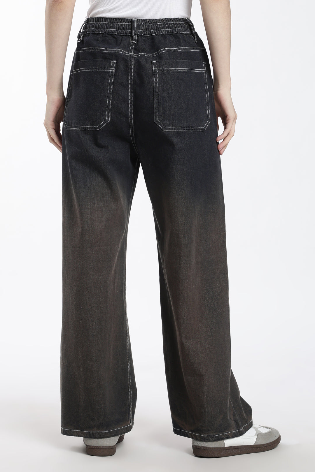 woman wearing dark vintage wash wide-leg denim jogger on a white background
