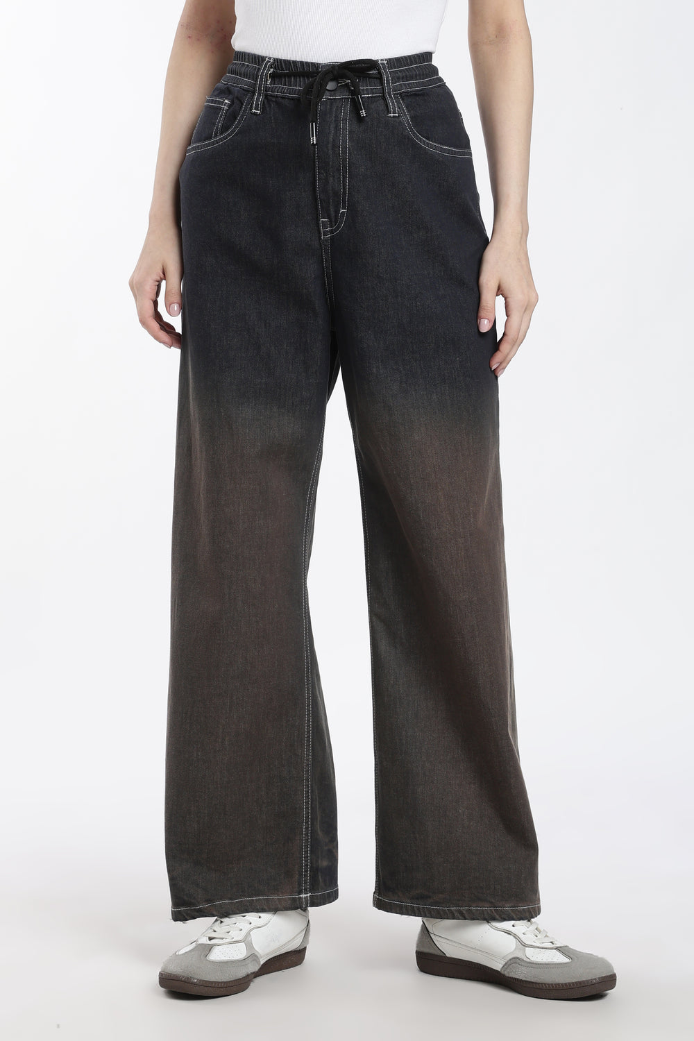 woman wearing dark vintage wash wide-leg denim jogger on a white background