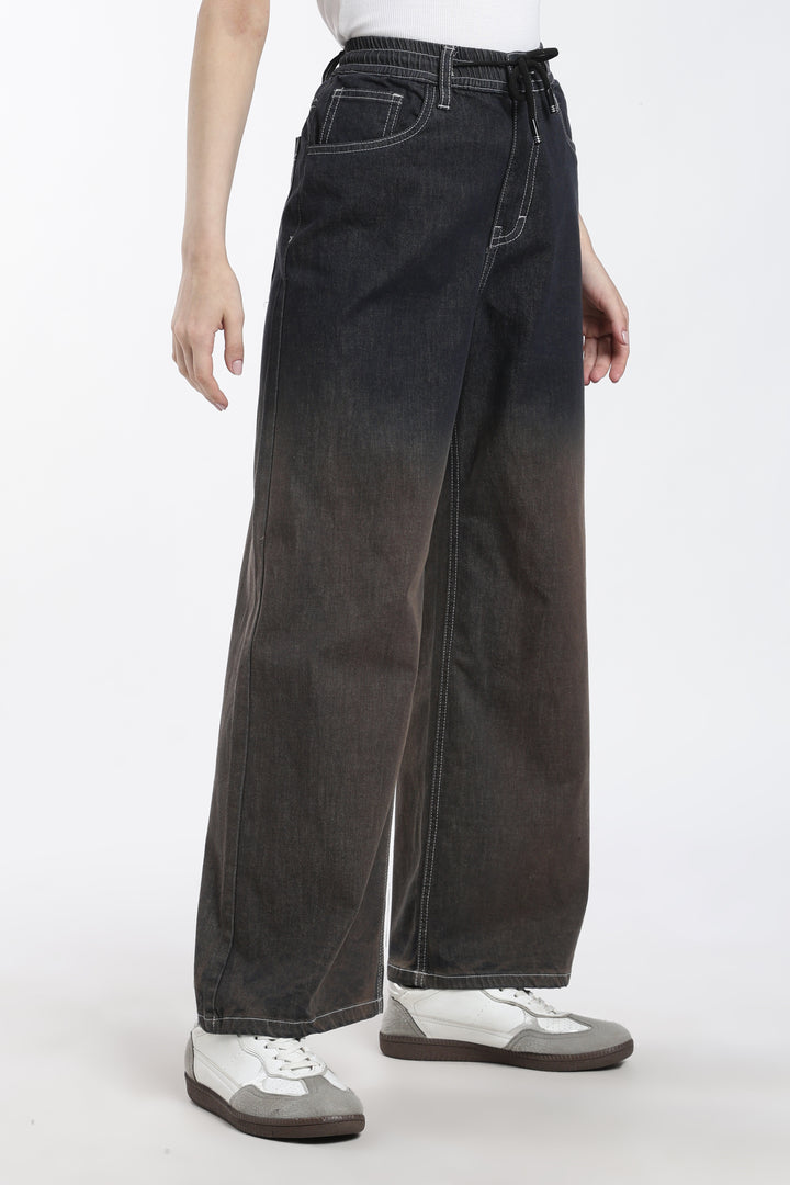 woman wearing dark vintage wash denim jogger on a white background