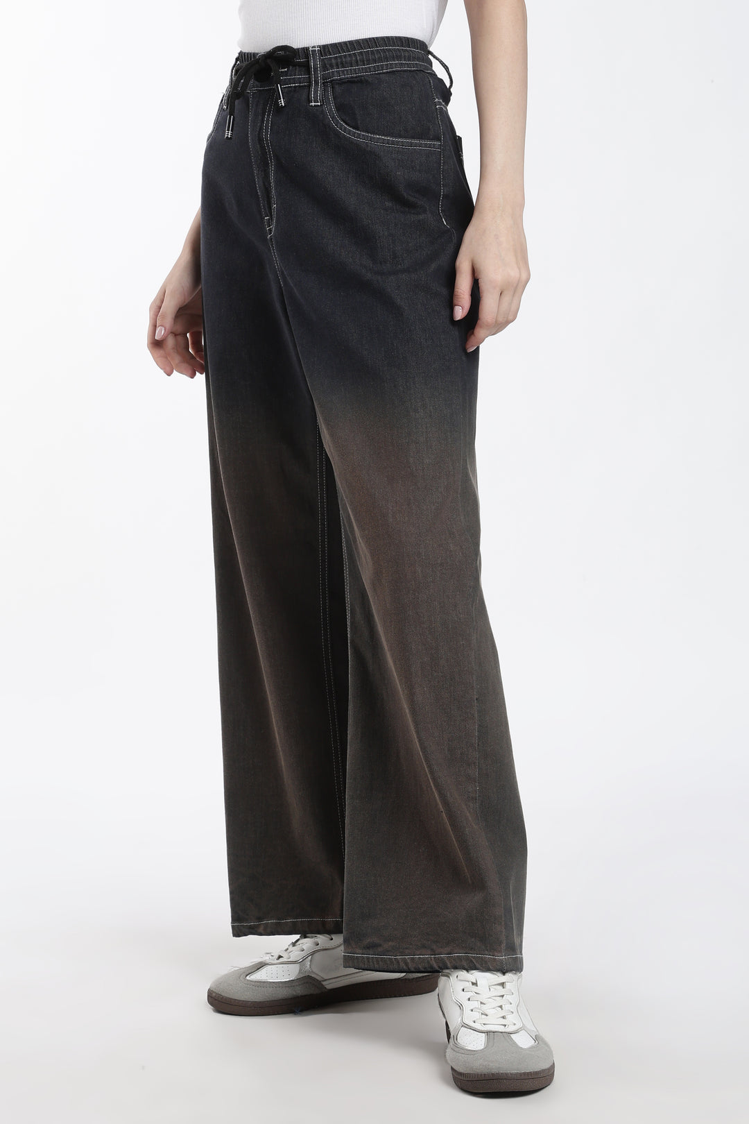 woman wearing dark vintage wash wide-leg denim jogger on a white background