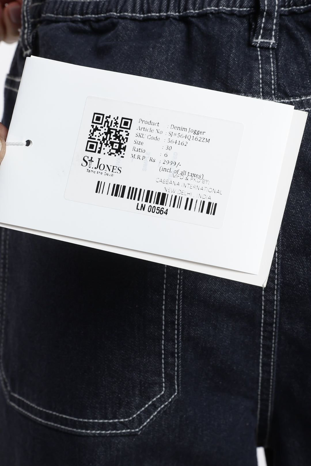 Close-up of a denim jogger with a brand saint jones and QR code.