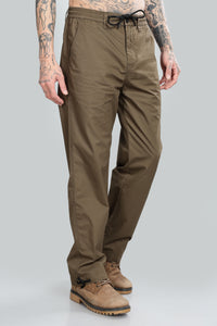 man wearing brown straight pant on light background 